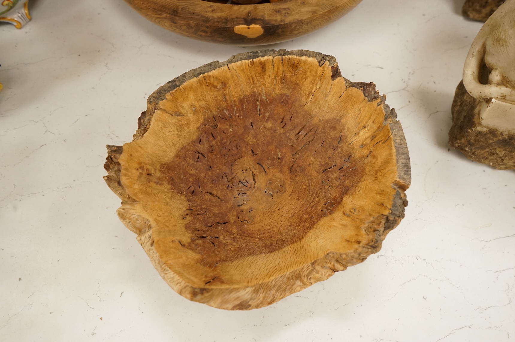 A modern treen yew bowl, a burr wood bowl and various fruit
